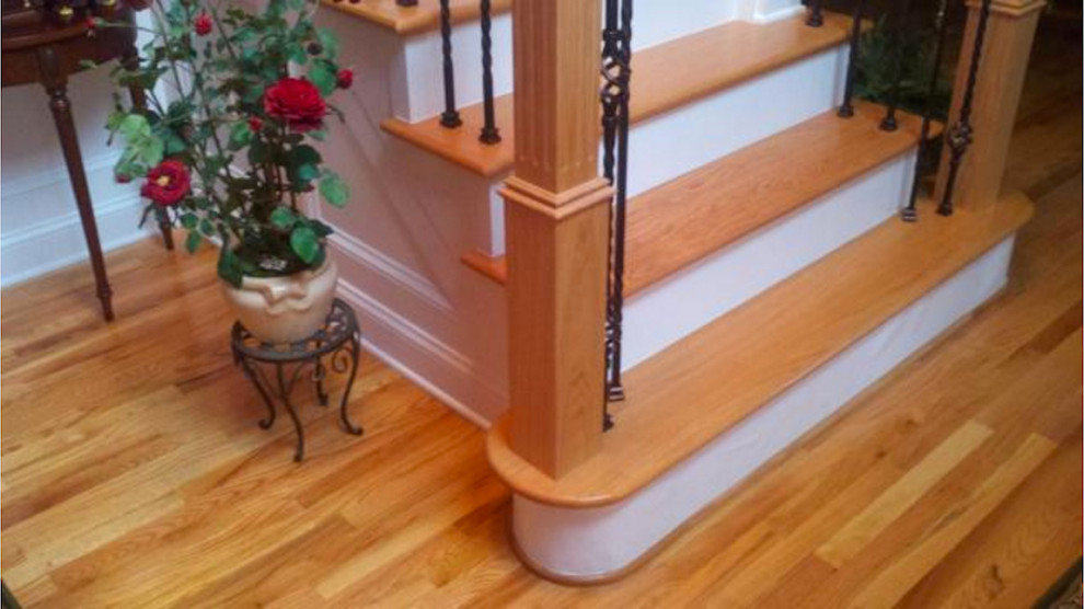 Design ideas for a mid-sized traditional wood u-shaped staircase in Baltimore with wood risers and wood railing.