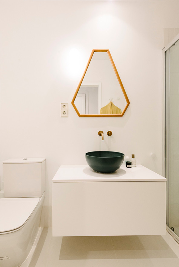 Small scandinavian master wet room bathroom in Madrid with furniture-like cabinets, white cabinets, a one-piece toilet, white tile, ceramic tile, white walls, ceramic floors, a vessel sink, engineered quartz benchtops, white floor, a sliding shower screen and white benchtops.