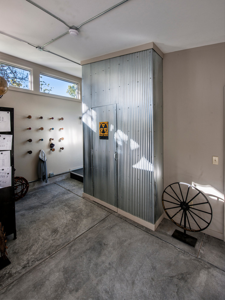 This is an example of an industrial entryway in Other with concrete floors and white walls.