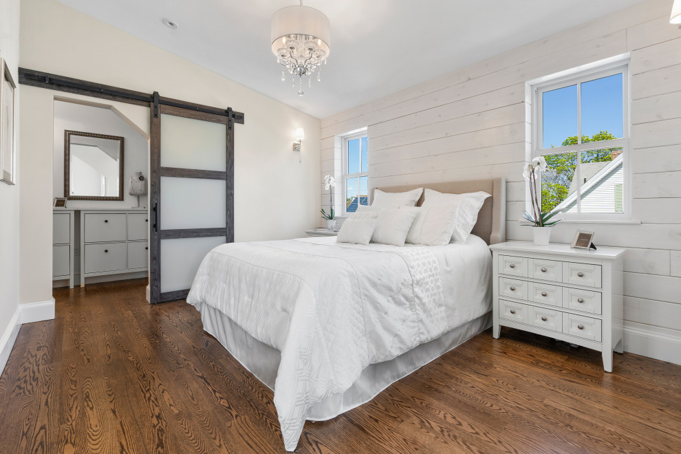 Inspiration for a mid-sized transitional master bedroom in Boston with white walls, dark hardwood floors, brown floor, vaulted and planked wall panelling.