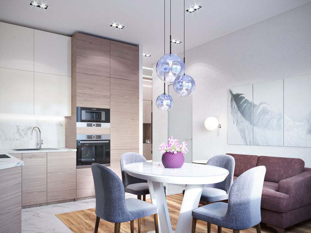 Единая зона кухни, столовой и гостиной.