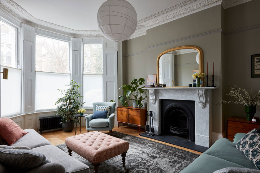 Photo of a large victorian living room in London with green walls, medium hardwood flooring, a standard fireplace and a stone fireplace surround.