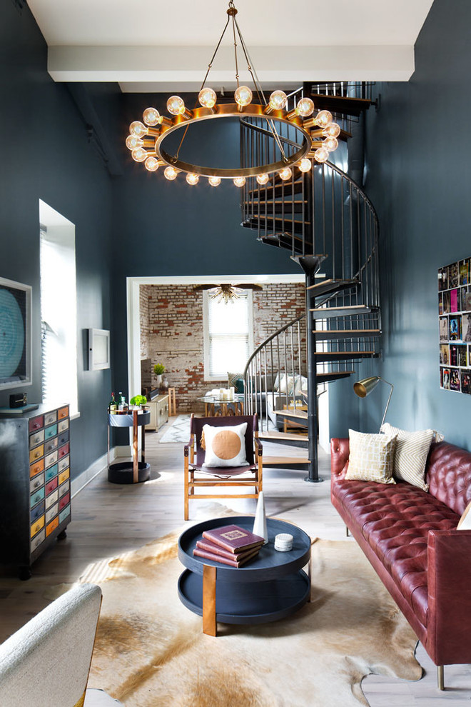 Inspiration for a large eclectic enclosed living room in New York with blue walls and light hardwood floors.