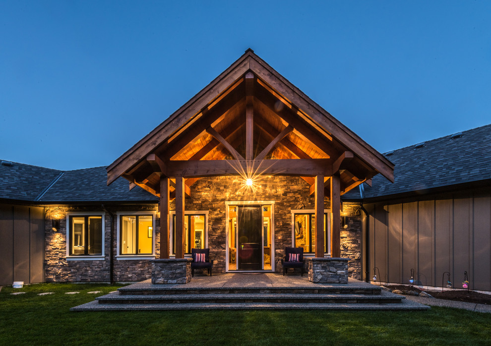 Large mountain style backyard concrete entryway photo with a roof extension