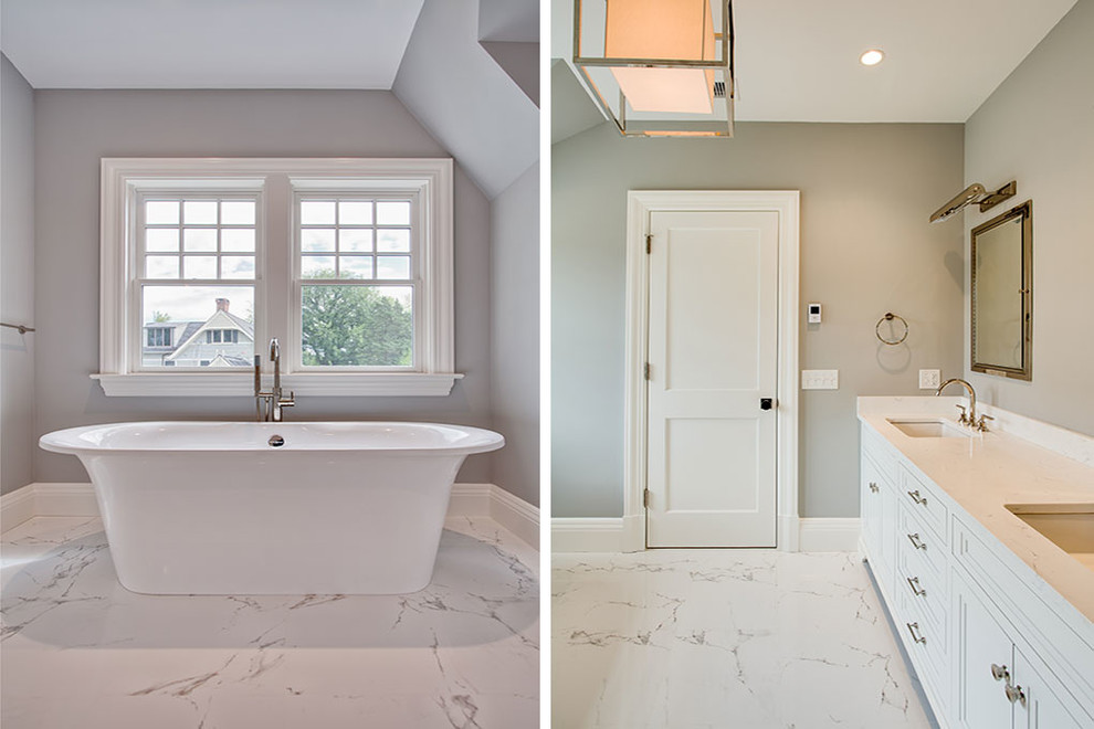 Transitional master white floor freestanding bathtub photo with recessed-panel cabinets, white cabinets, gray walls, an undermount sink, marble countertops and a hinged shower door
