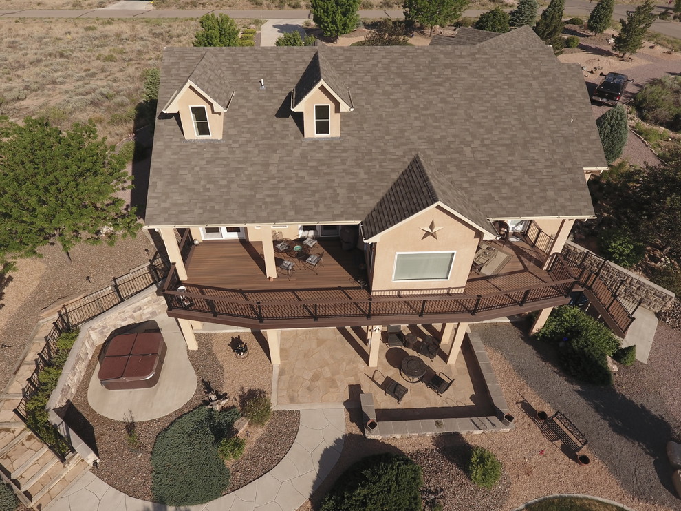 Example of a large transitional backyard deck design in Denver