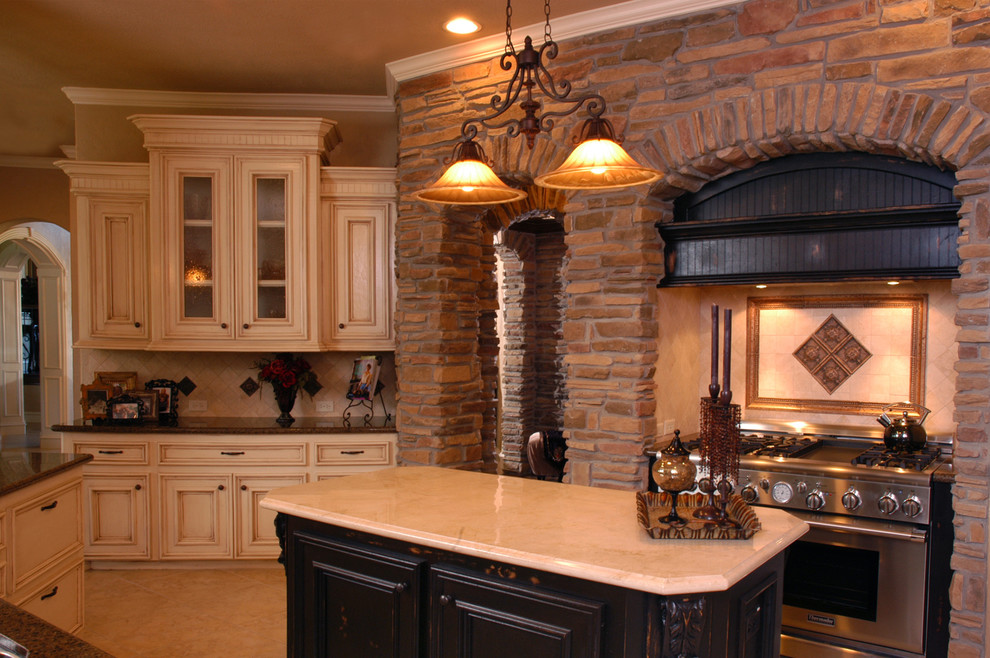 Eat-in kitchen photo in Houston with distressed cabinets, marble countertops, beige backsplash, custom tile backsplash and stainless steel appliances