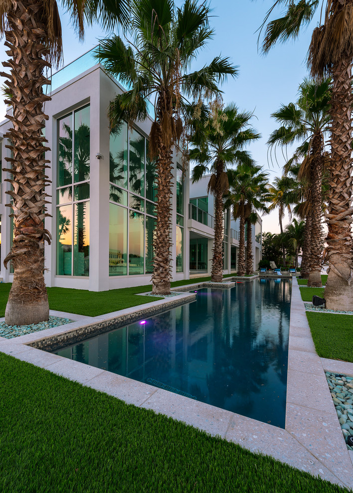 Inspiration for a contemporary stucco white exterior in Miami with a flat roof.