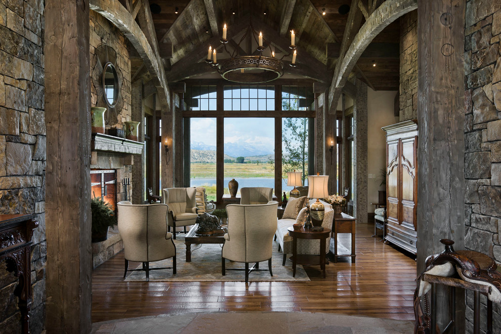 Inspiration for a country open concept living room in Other with a standard fireplace and a stone fireplace surround.