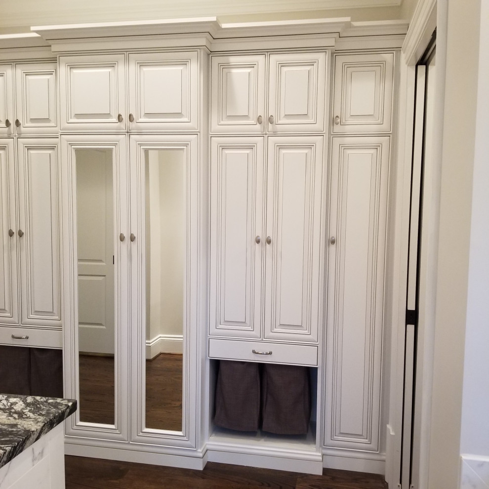 Small traditional storage and wardrobe in DC Metro with raised-panel cabinets, white cabinets and dark hardwood floors.