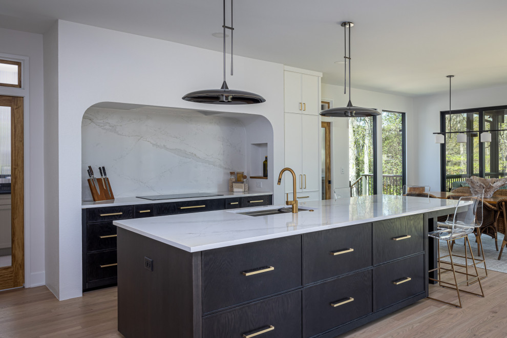 Inspiration for a large transitional medium tone wood floor open concept kitchen remodel in Raleigh with an undermount sink, beaded inset cabinets, white cabinets, quartz countertops, white backsplash, quartz backsplash, paneled appliances, an island and white countertops