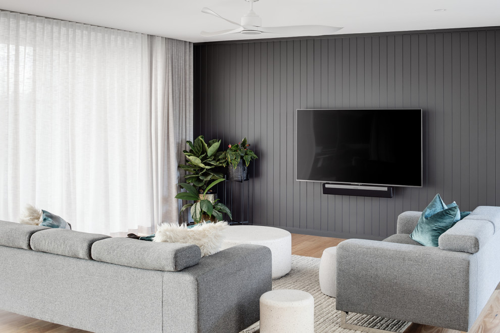 Inspiration for a contemporary living room in Brisbane with grey walls, light hardwood floors, a wall-mounted tv and beige floor.