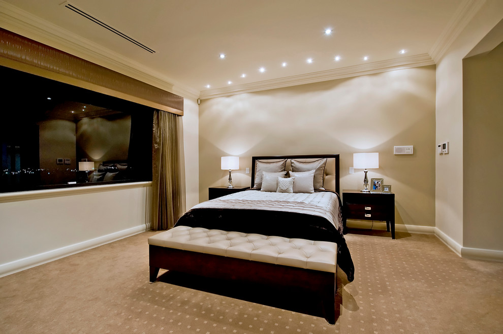 This is an example of a large contemporary master bedroom in Perth with beige walls and carpet.