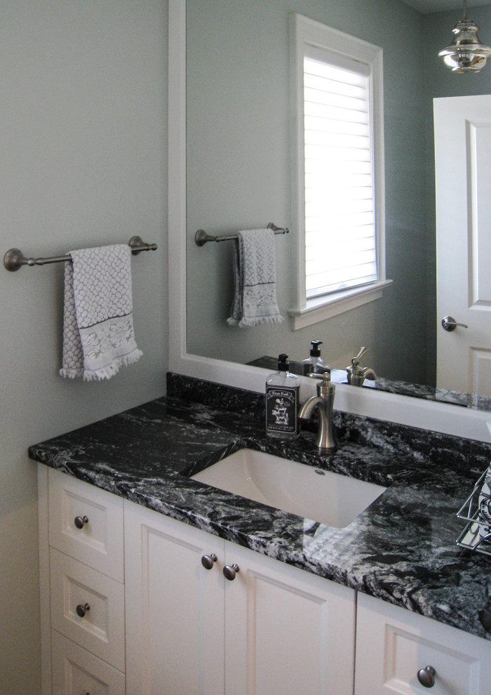 Transitional bathroom photo in Toronto with white cabinets, blue walls, an undermount sink and granite countertops