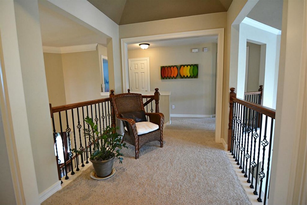 Photo of a mid-sized transitional hallway in Houston with beige walls, carpet and beige floor.