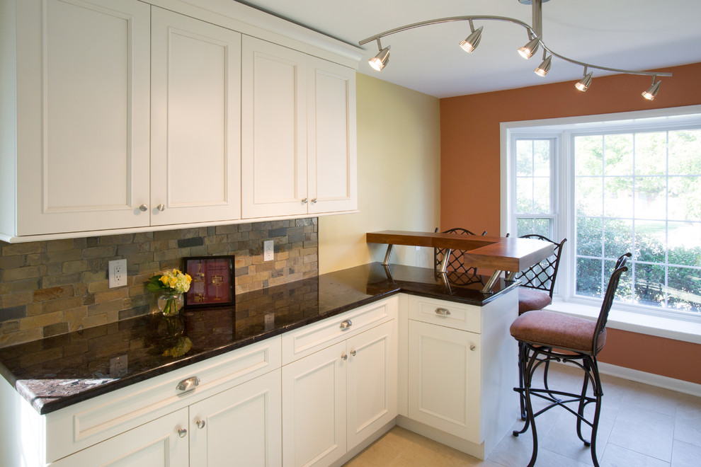 Mid-sized transitional galley eat-in kitchen in DC Metro with an undermount sink, shaker cabinets, white cabinets, granite benchtops, green splashback, slate splashback, stainless steel appliances, porcelain floors and a peninsula.