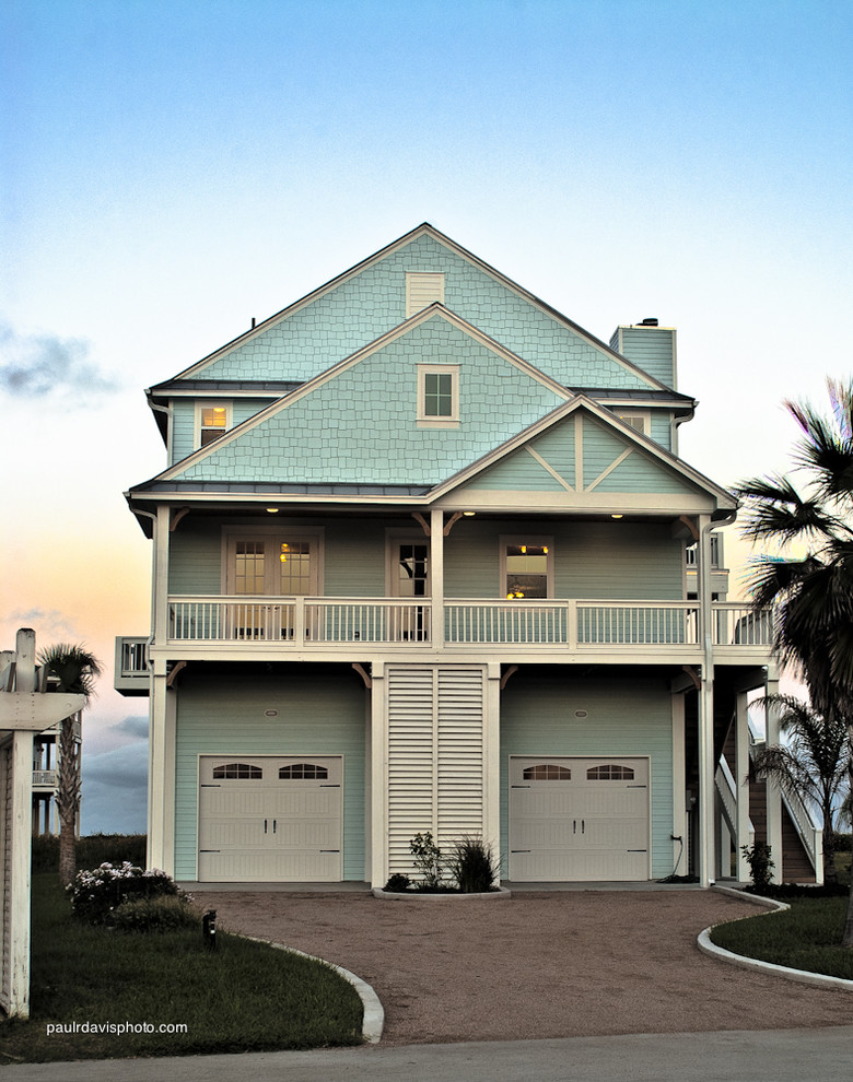 Design ideas for a mid-sized beach style three-storey blue exterior in Houston with concrete fiberboard siding and a gable roof.