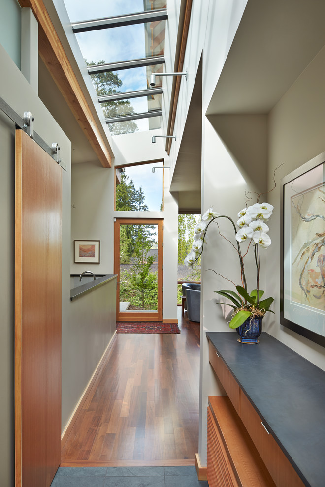 Inspiration for a contemporary hallway in Seattle with grey walls and medium hardwood floors.