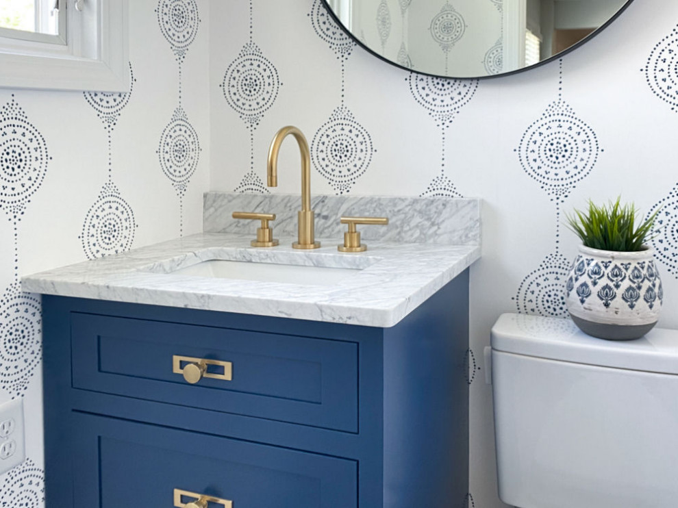 Inspiration for a small traditional cloakroom in Boston with shaker cabinets, blue cabinets, a two-piece toilet, marble flooring, a submerged sink, marble worktops, grey floors, grey worktops, a built in vanity unit and wallpapered walls.