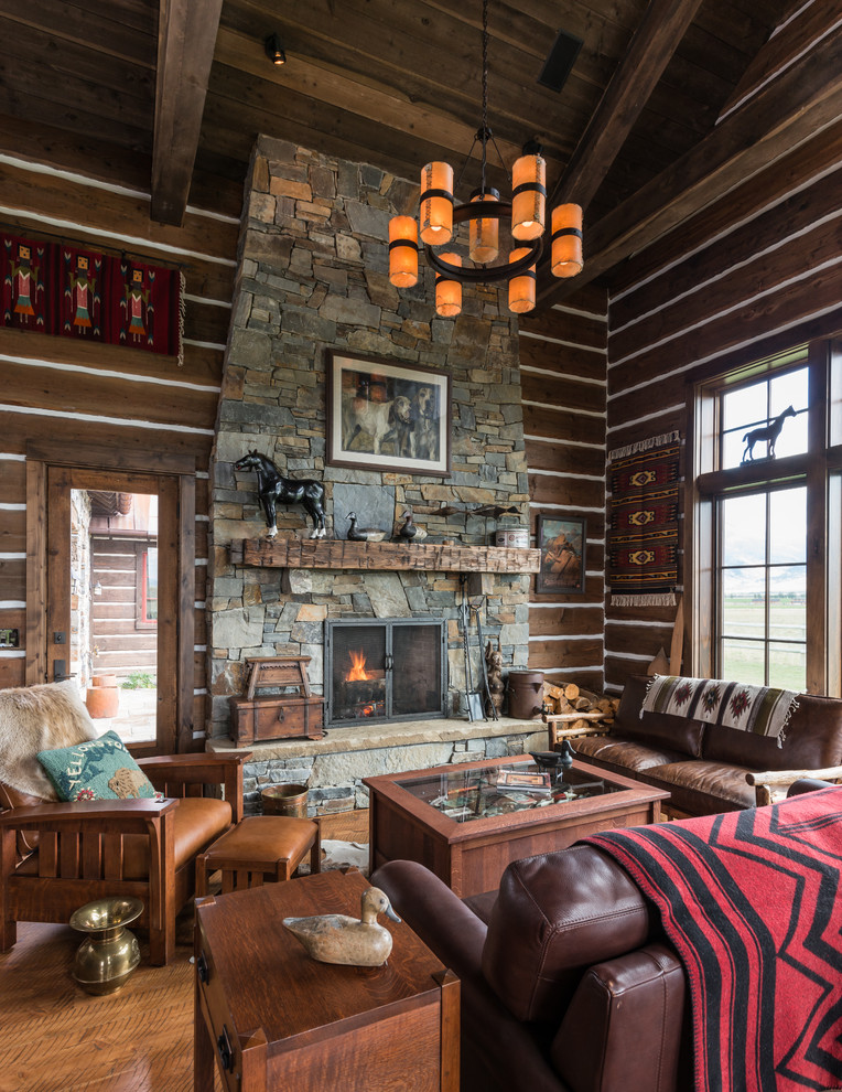 Photo of an open concept living room in Other with brown walls, medium hardwood floors, a standard fireplace, a stone fireplace surround and no tv.