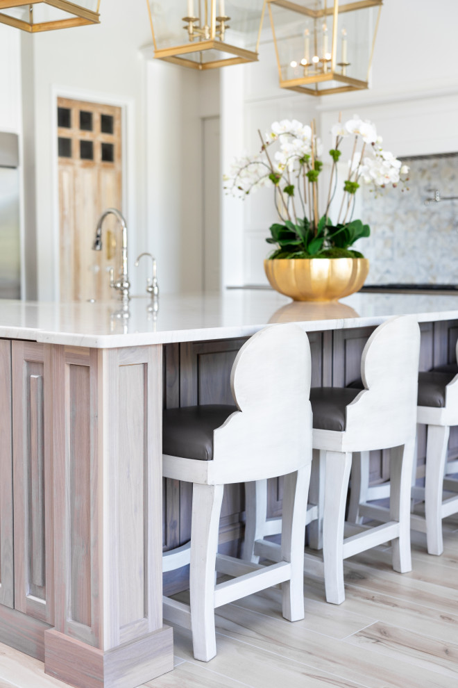 Example of a large transitional porcelain tile and beige floor kitchen design in Orlando with a farmhouse sink, recessed-panel cabinets, white cabinets, quartzite countertops, multicolored backsplash, marble backsplash, stainless steel appliances, an island and beige countertops