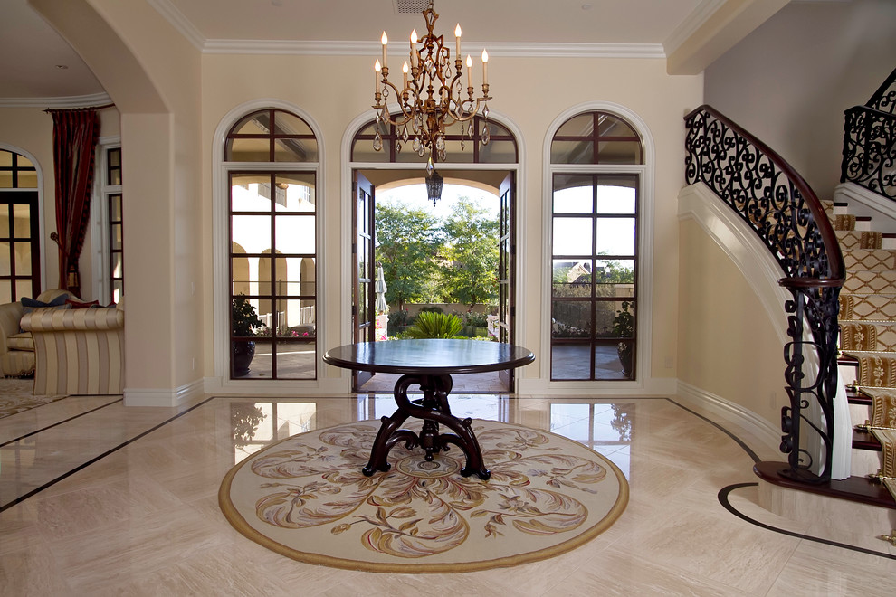 This is an example of a large traditional foyer in Phoenix with beige walls, marble floors, a double front door and a glass front door.