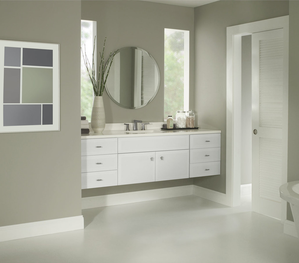 Inspiration for a contemporary master bathroom in Raleigh with an undermount sink, flat-panel cabinets, white cabinets, a freestanding tub and grey walls.
