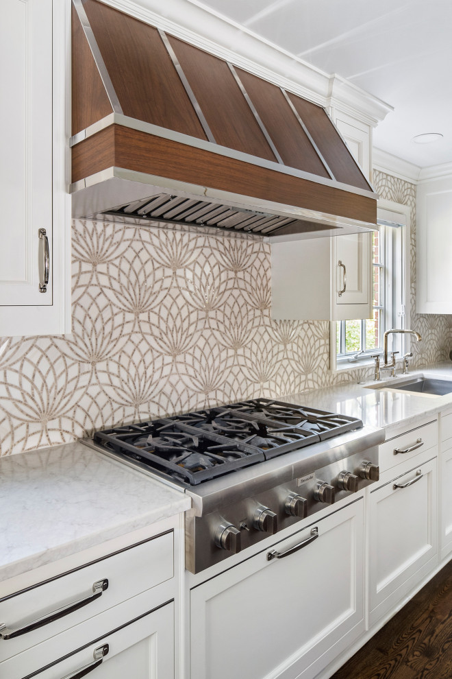 Inspiration for a large transitional l-shaped eat-in kitchen in Detroit with an undermount sink, beaded inset cabinets, white cabinets, quartz benchtops, beige splashback, mosaic tile splashback, panelled appliances, dark hardwood floors, with island, brown floor and beige benchtop.