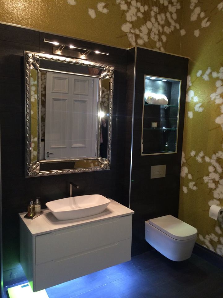 Photo of a large contemporary master bathroom in Glasgow with a console sink, a freestanding tub, a wall-mount toilet, gray tile, porcelain tile, multi-coloured walls and porcelain floors.