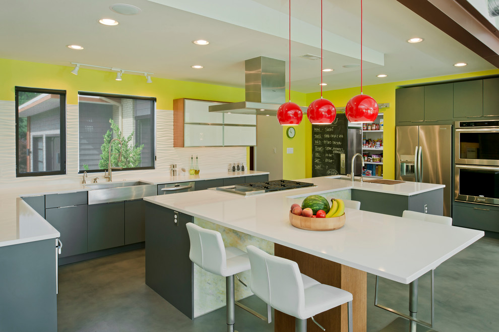 This is an example of a large contemporary l-shaped open plan kitchen in Baltimore with an undermount sink, flat-panel cabinets, grey cabinets, quartz benchtops, white splashback, cement tile splashback, stainless steel appliances, concrete floors, with island, grey floor and white benchtop.
