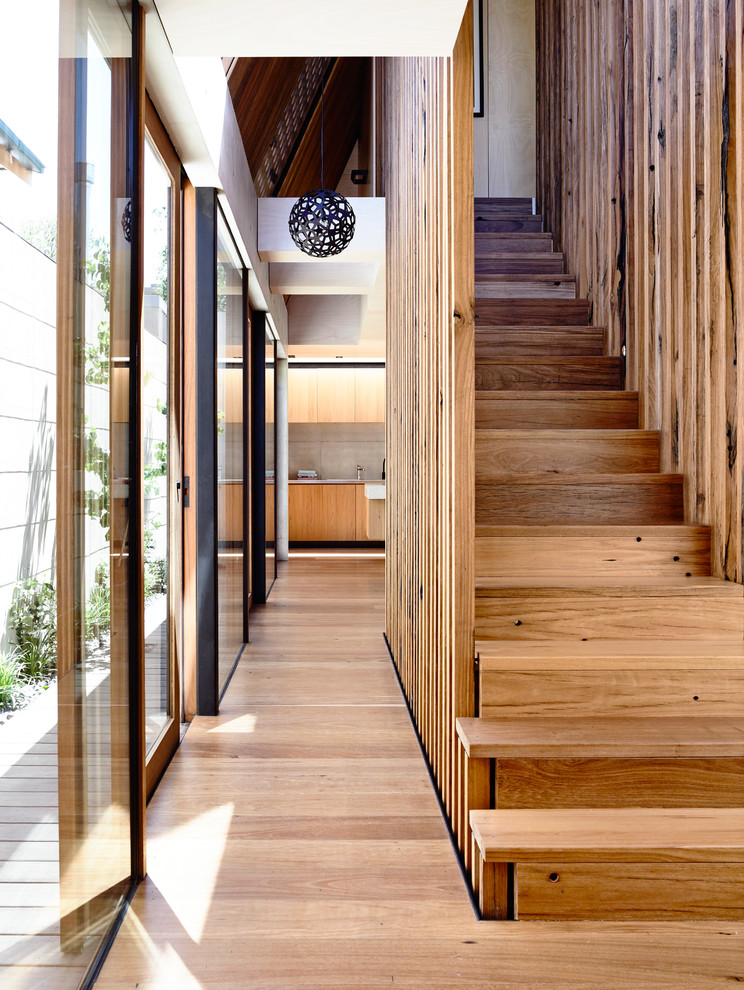 Photo of a mid-sized modern wood straight staircase in Melbourne with wood risers.