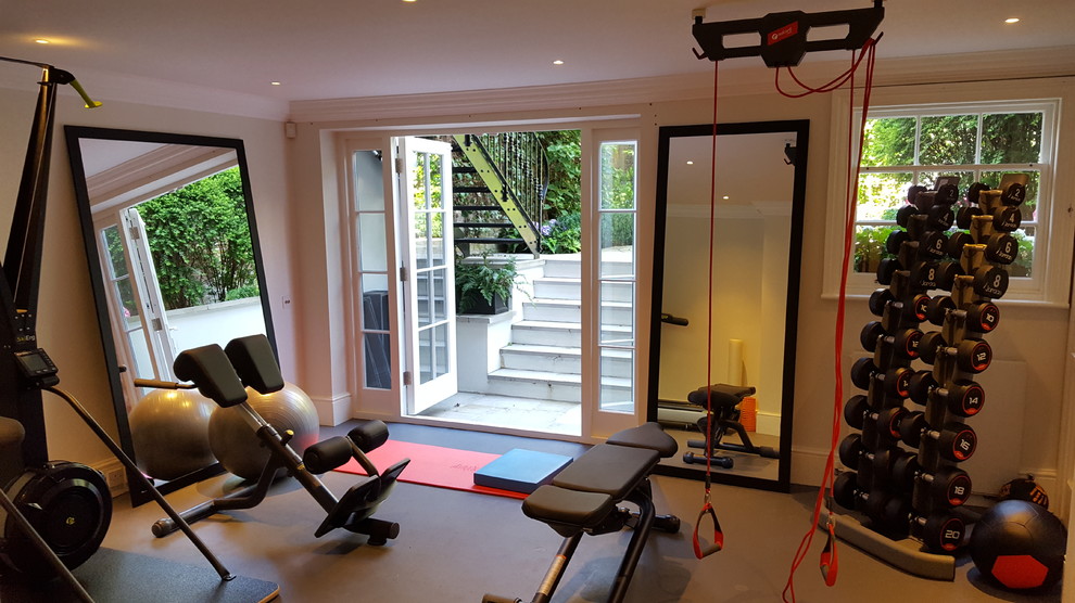 Small contemporary home weight room in London with beige walls and grey floor.