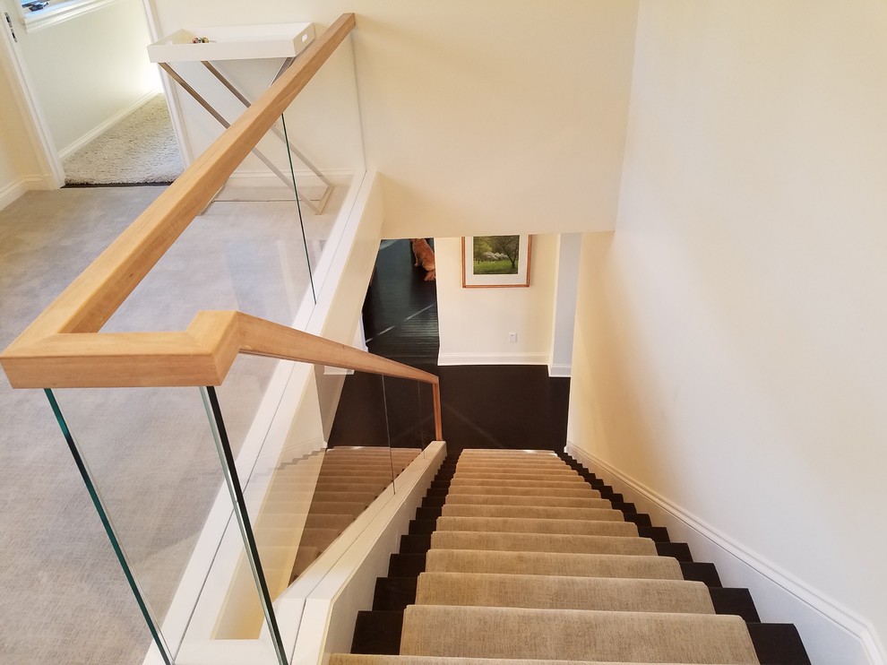 Mid-sized modern wood straight staircase in New York with wood risers and mixed railing.