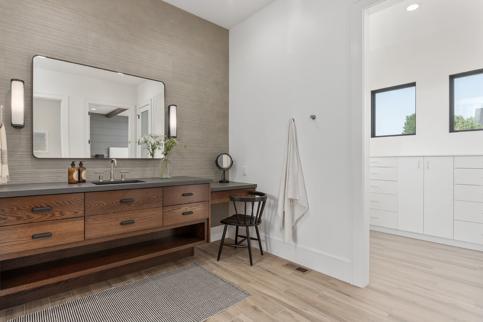 Inspiration for a large contemporary master bathroom in Salt Lake City with flat-panel cabinets, medium wood cabinets, a corner shower, a one-piece toilet, gray tile, porcelain tile, white walls, porcelain floors, an undermount sink, quartzite benchtops, beige floor, a hinged shower door and grey benchtops.