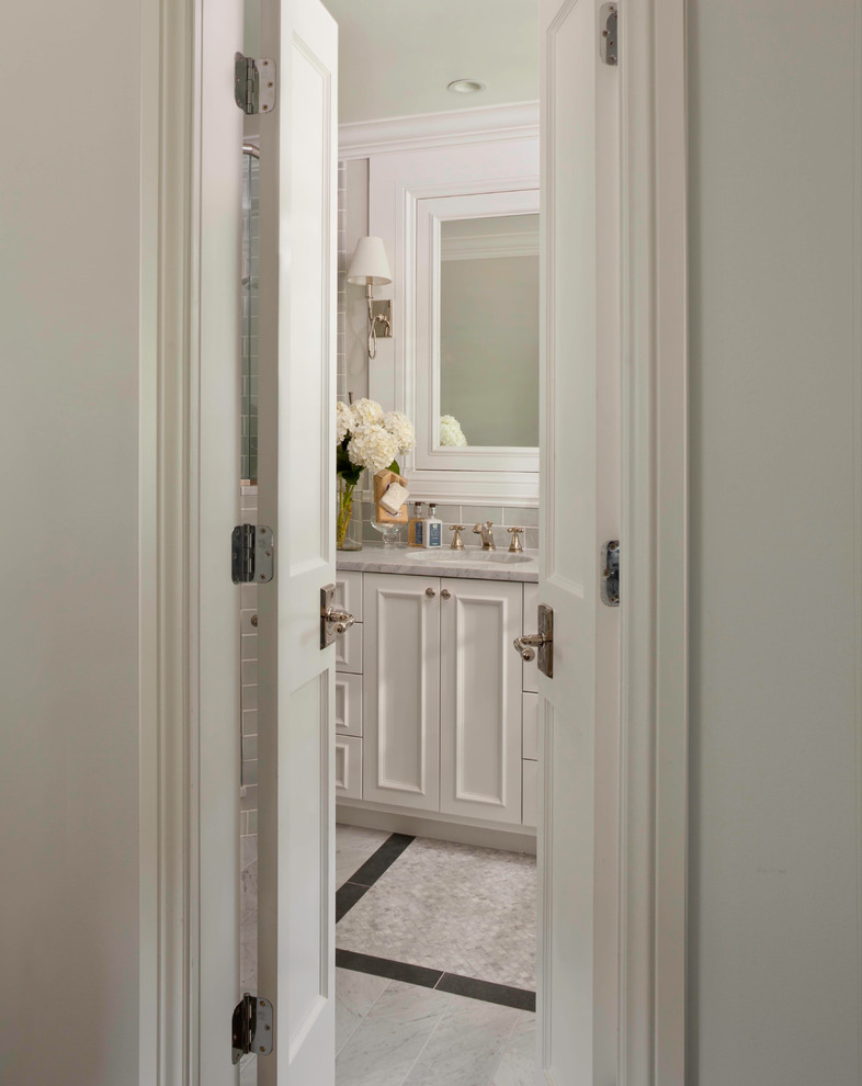 Traditional master bathroom in Denver with an undermount sink, recessed-panel cabinets, white cabinets, marble benchtops, a corner shower, a two-piece toilet, green tile, ceramic tile, green walls and marble floors.