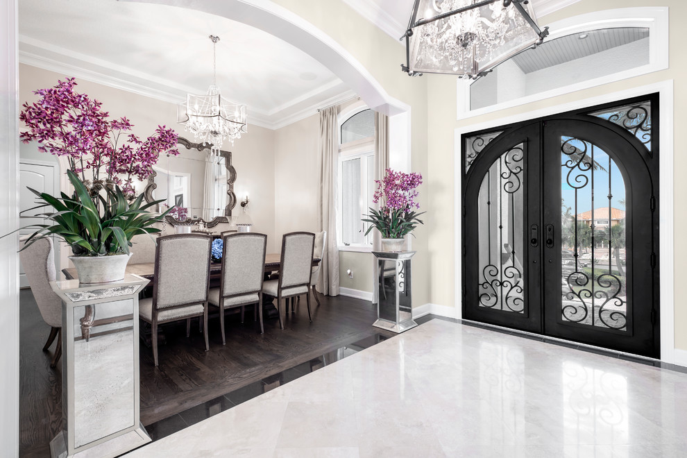 Photo of a large traditional foyer in Tampa with beige walls, marble floors, a double front door, a metal front door and beige floor.