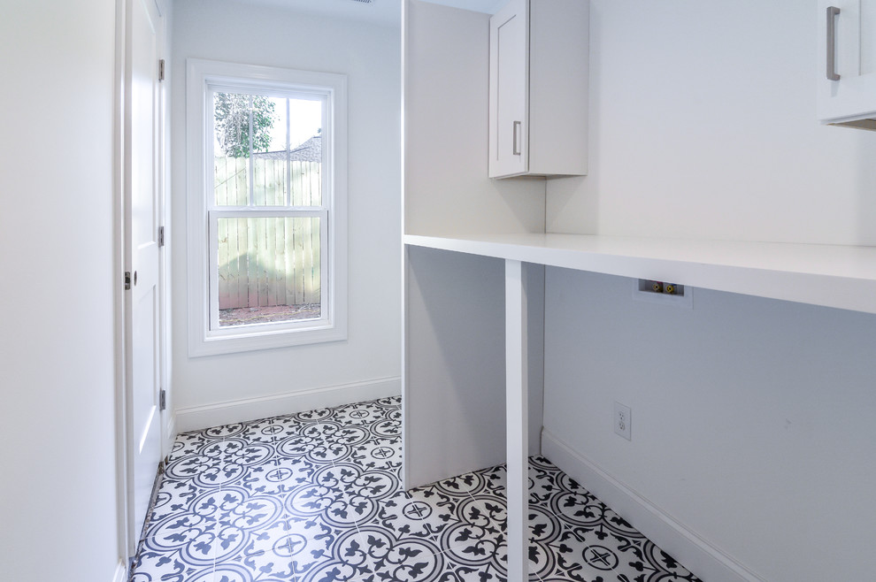 Design ideas for a mid-sized traditional single-wall dedicated laundry room in Charlotte with shaker cabinets, white cabinets, wood benchtops, white walls, ceramic floors, a side-by-side washer and dryer, multi-coloured floor and white benchtop.
