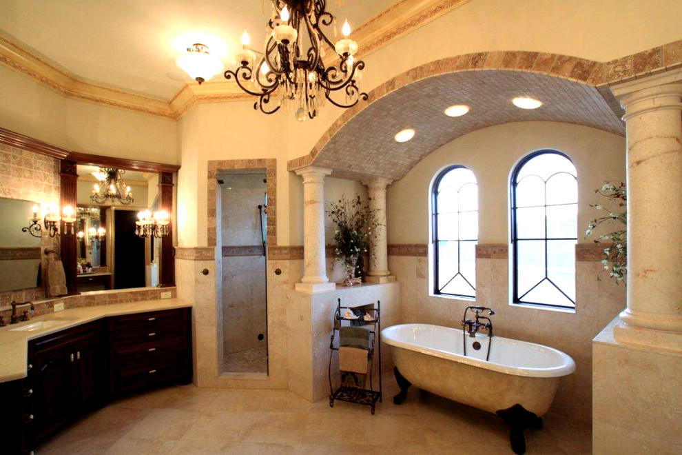 Large mediterranean master bathroom in Tampa with furniture-like cabinets, dark wood cabinets, marble benchtops, a claw-foot tub, an open shower, a two-piece toilet, multi-coloured tile, cement tile, beige walls, marble floors and an undermount sink.