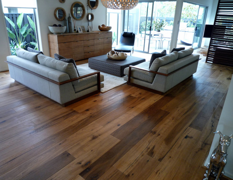 Family room - large modern open concept medium tone wood floor family room idea in Miami with white walls, no fireplace and no tv