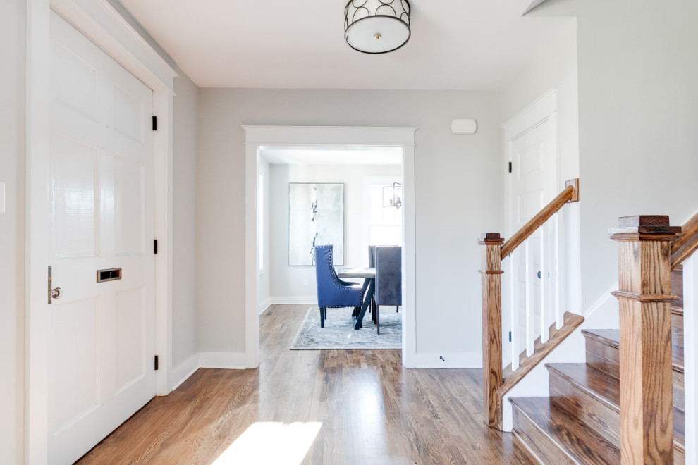 This is an example of a mid-sized traditional foyer in Richmond with grey walls, medium hardwood floors, a single front door, a blue front door and brown floor.