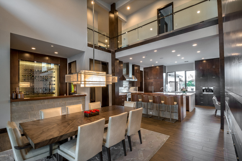 Inspiration for an expansive contemporary kitchen/dining combo in Orange County with grey walls, porcelain floors and brown floor.