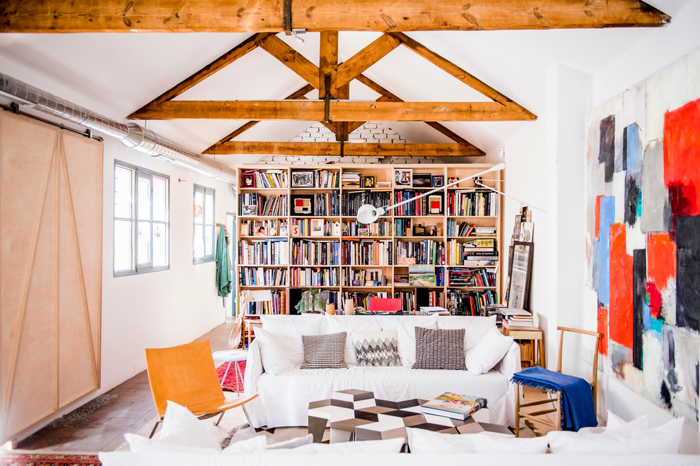 Mid-sized eclectic enclosed family room in Madrid with a library, white walls, no fireplace and no tv.