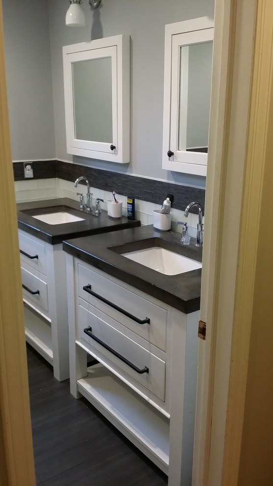 Photo of a mid-sized transitional kids bathroom in New York with furniture-like cabinets, white cabinets, gray tile, ceramic tile, an undermount sink and concrete benchtops.