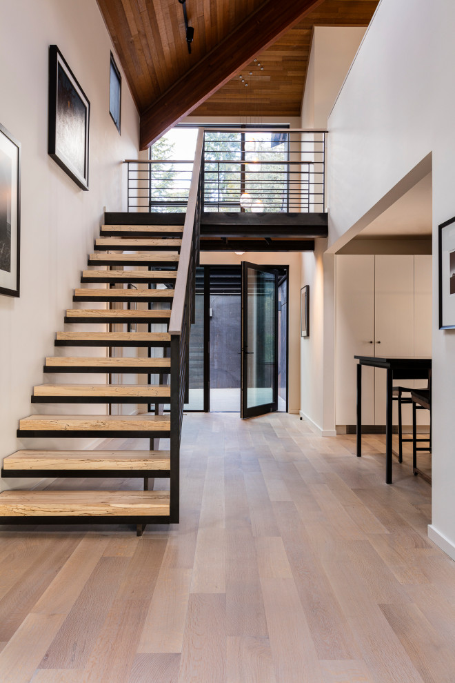 Contemporary wood straight metal railing staircase in Seattle with open risers.