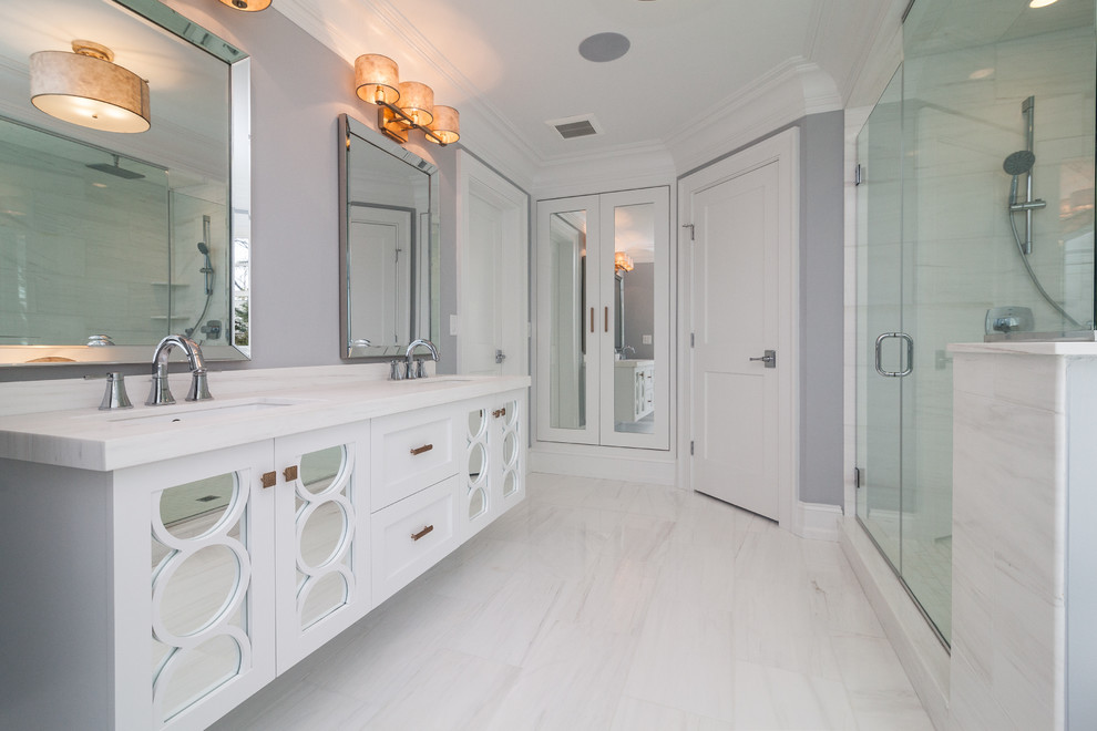 Inspiration for a mid-sized transitional master bathroom in New York with shaker cabinets, white cabinets, an alcove shower, grey walls, porcelain floors, an undermount sink, marble benchtops and a freestanding tub.