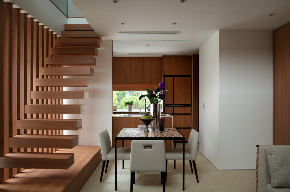 This is an example of a small contemporary open plan dining in Tokyo with white walls and no fireplace.
