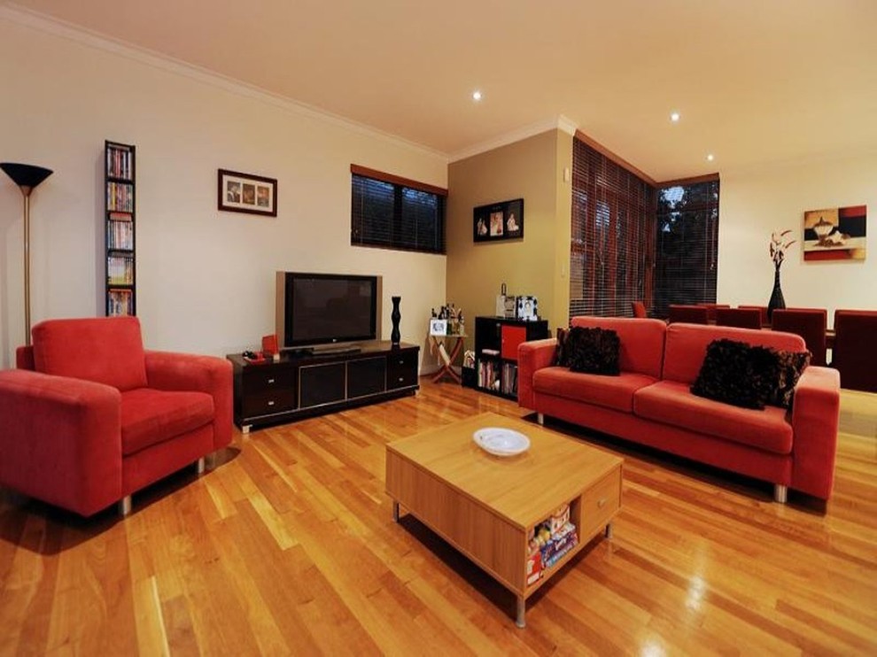 Photo of a small contemporary open concept living room in Perth with green walls and light hardwood floors.