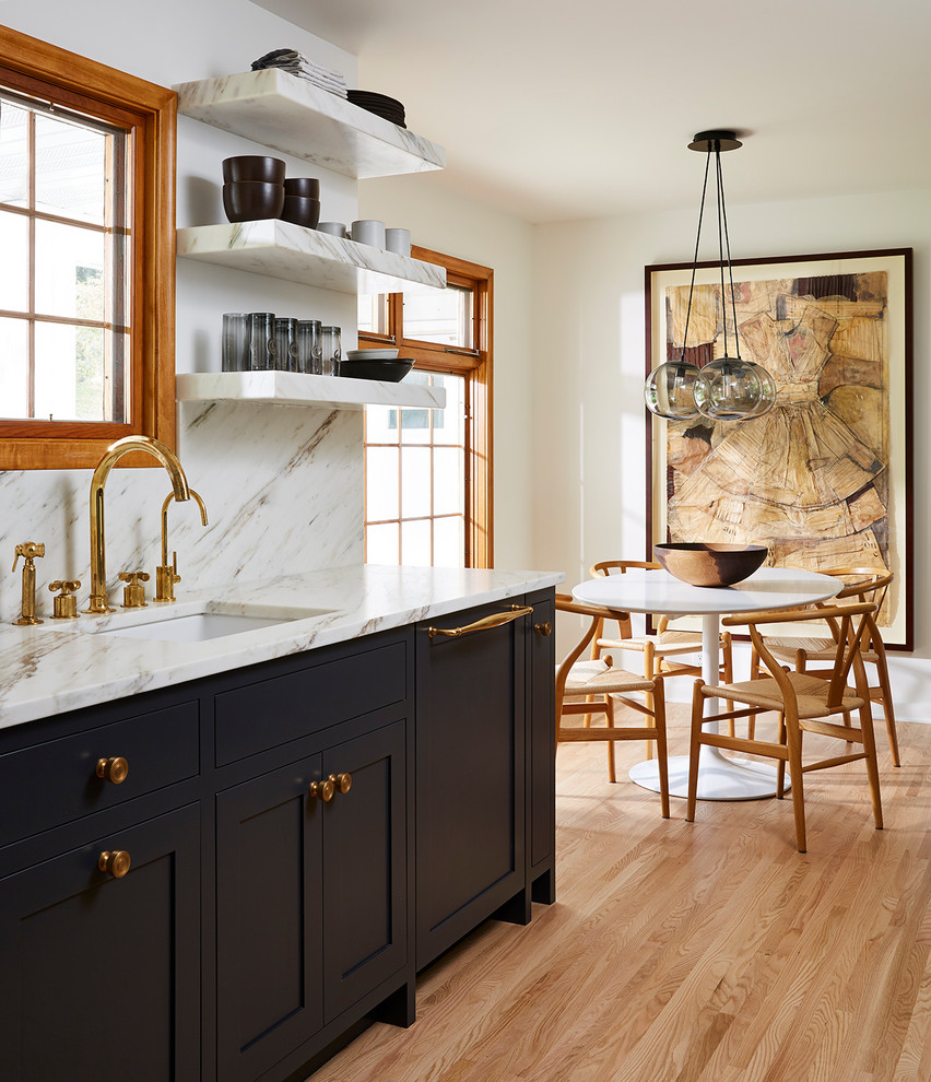 Design ideas for a transitional galley eat-in kitchen in Minneapolis with an undermount sink, shaker cabinets, black cabinets, grey splashback, medium hardwood floors, no island, brown floor and grey benchtop.