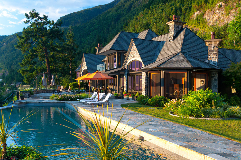 Design ideas for a traditional rectangular pool in Vancouver with natural stone pavers.