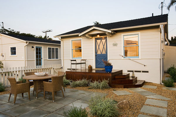 Mid-sized beach style one-storey beige exterior in Santa Barbara with wood siding.